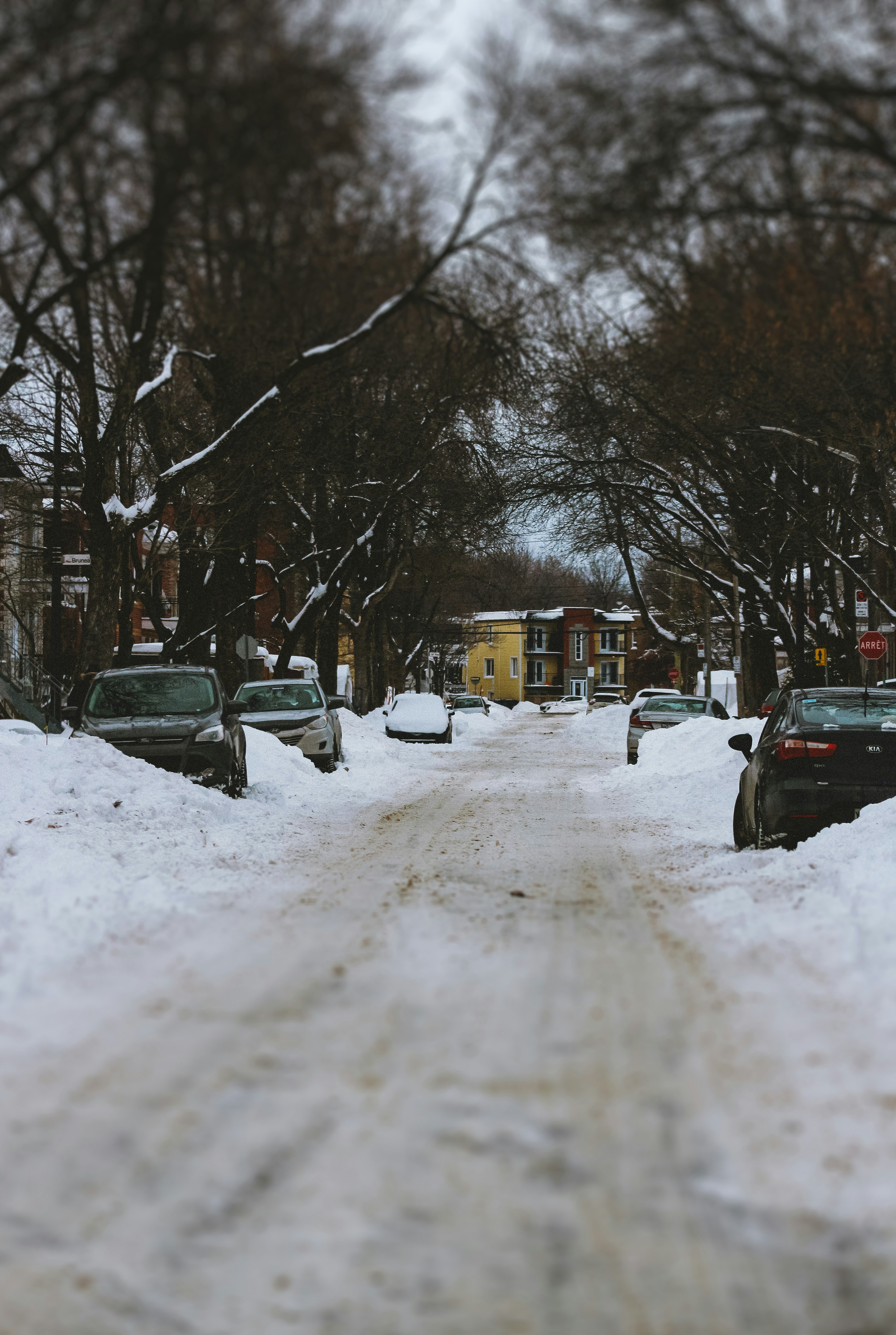 black car on snow covered road during daytime